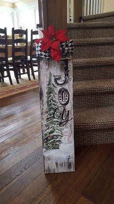 a wooden sign sitting on top of a hard wood floor next to a stair case