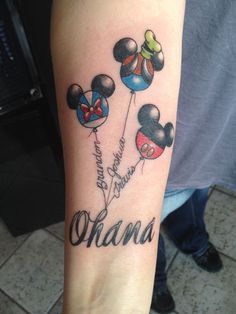 a person with a tattoo on their arm that says, obama and mickey mouse balloons