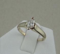 "This classic dazzling marquise cut diamond solitaire in 14K yellow gold is representative of the traditional promise ring. The diamond is set high enough to allow for the future addition of a wedding band. FREE SHIPPING! Details: 14k Yellow Gold (shown in picture) Natural Diamond: (1) 4.1 mm x 7.4 mm marquise Approximate Diamond Weight: 0.40 ctw Diamond Clarity: SI3 Diamond Color: H Ring Size: 7 Total Weight: 3.5 grams FREE Domestic Shipping by USPS Priority Mail Signature Confirmation and incl 14k Gold Marquise Cut Diamond Ring With Tension Setting, 14k White Gold Marquise Rings, White Gold Marquise Cut Wedding Ring With Tension Setting, 14k Gold Marquise Cut Ring With Tension Setting, Marquise Solitaire Yellow Gold Diamond Ring, Yellow Gold Solitaire Marquise Diamond Ring, Fine Jewelry Marquise Cut Diamond Ring With Tension Setting, Marquise Tension Setting Rings For Anniversary, Marquise Tension Setting Fine Jewelry