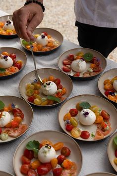 a table topped with plates filled with different types of food on top of each other