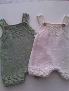 two knitted baby rompers laying next to each other