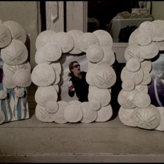 the letters made out of towels are displayed in front of a window with an image of a man