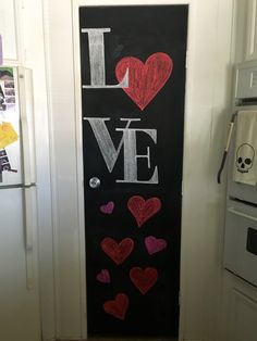 a chalkboard with the words i love written on it in front of a door