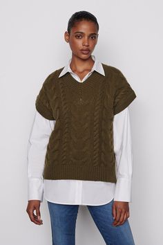 This cable-knit V-neck sweater is equal parts timeless and nostalgic, à la preppy ’90s style. It’s spun from 100% extra-fine Merino wool and designed for an oversized fit that we loved layered over everything from T-shirts to button-downs and dresses. 100% Extra Fine Merino Wool Dry Clean Only 22.5" Long From Shoulder Model is 5'11" Tall/180 cm and is Wearing a US Size S Tie Up Shirt, Preppy 90s, New Frame, Wool Vest, Coastal Chic, 90s Style, Hawaiian Print, Menswear Inspired, And Dresses