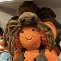 two stuffed animals are on top of each other in a shelf with many other stuffed animals