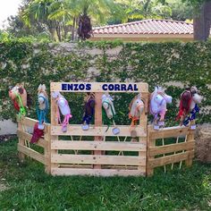 several horses are standing in a fenced area with the words enos coral written on it