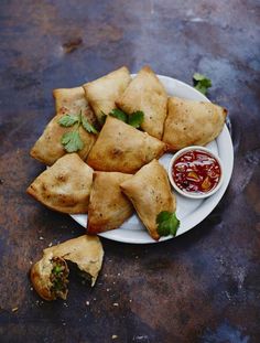 some food is on a plate with dipping sauce