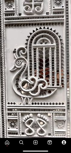 an intricate metal door with a bird in the cage on it's front side