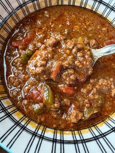 a bowl filled with chili and meat soup