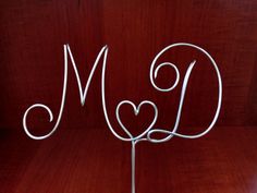 a cake topper with the letter m on it