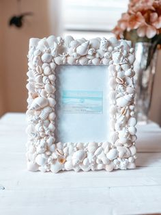 a white frame sitting on top of a table