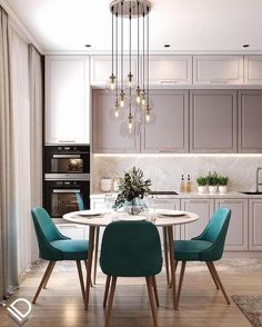 a dining room table with chairs and a chandelier hanging from it's ceiling