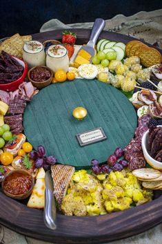 a table topped with lots of different types of foods and meats next to each other