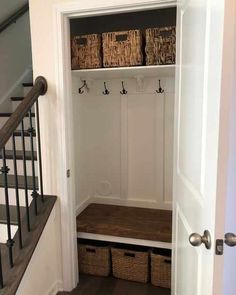 an entry way with some baskets on the shelf