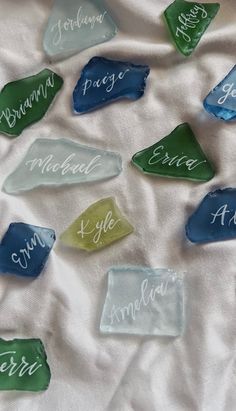 several different colored glass pieces with names on them