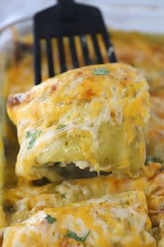 a fork is lifting up some food out of the casserole