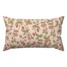 a white pillow with red and green leaves on it