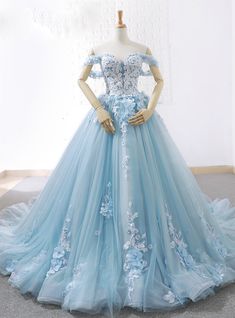 Add a hint of color with this absolutely gorgeous icy blue wedding ball gown where the floral motifs are appliqued throughout the silhouette. The strapless sweetheart neckline is beautiful, bridal and unique with the intricate network of organic florals appliqued together in a presentable fashion. Baby Blue Prom Dresses, Blue Ball Gown, Ball Gown Prom Dresses, Blue Ball Gowns, Long Prom Gowns, Blue Wedding Dresses, Tulle Ball Gown, Gown Prom, Sweet 16 Dresses