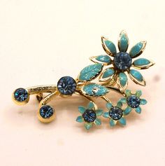 This Vintage 3 Dimensional light Blue Enamel and sparkling light Blue Rhinestone Brooch has flower like daisies and a safety clasp. Measures:  52.15 mm x 38.96 mm x 10.30 mm Vintage Blue Jewelry Brooch, Blue Floral Brooch Jewelry, Wedding Flower-shaped Enamel Brooches, Blue Flower-shaped Jewelry Brooch, Formal Flower-shaped Enamel Brooches, Luxury Flower-shaped Enamel Brooches, Sparkling Lights, Enamel Flower, Rhinestone Brooches