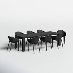 a long table with chairs around it on a white background in front of a gray wall