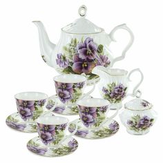 a tea set with purple flowers on it