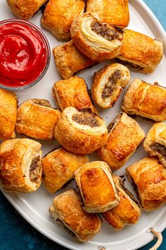 several pastries on a white plate with ketchup