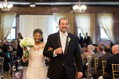 a bride and groom walking down the aisle