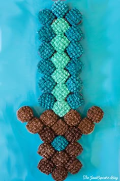 two knitted teddy bears sitting next to each other on a blue surface with water in the background