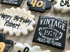 decorated cookies with happy birthday robert and forty years written on the front, in black and white