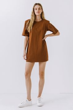 This Shoulder Pad T-Shirt Dress is a wardrobe must-have! Featuring a stylish round neckline, short sleeves, and a boxy silhouette, it's the perfect addition to any outfit. Our unique shoulder pad insert adds structure and a touch of sass, making this dress a standout. With its comfortable fit and comfortability, you'll look amazing no matter what the occasion. Show off your fashion-forward style with this shoulder-pad t-shirt dress! Shoulder pad inserted Round neckline Short sleeves Boxy silhoue Brown Oversized Short Sleeve Dress, Oversized Short Sleeve T-shirt Dress, Chic Oversized Short Sleeve Mini Dress, Relaxed Fit Short Sleeve T-shirt Dress For Fall, Short Sleeve Everyday Fall Dresses, Everyday Short Sleeve Fall Dresses, Solid Color Cotton T-shirt Dress With Crew Neck, Cotton Crew Neck T-shirt Dress, Jumpsuit Fall