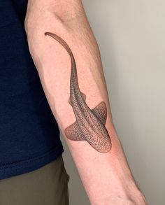 a man's arm with a lizard tattoo on it