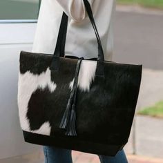 Explore the rich textures of a genuine brown and white cowhide bag, exuding a natural charm and irresistibly soft, velvety feel. - Enjoy complimentary shipping on all cowhide purses. - Dimensions: 14." L x 4" W x 9" H (Approx) - Front side crafted from genuine cowhide. - Back made of leather matching cowhide color. - Fully lined interior with 2 convenient zipper pockets. - Features a main zipper closure with zip ending outside the bag. - Each cowhide purse takes approximately seven business days Black White Hair, Fur Bags, Western Bag, Cowhide Purse, Cowhide Handbags, Cowhide Bag, Large Leather Tote Bag, Purse Handmade, Cow Skin