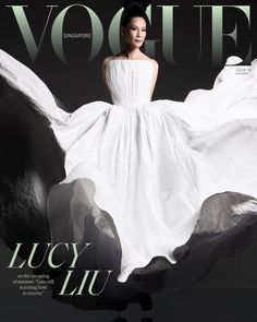 a woman in a white dress on the cover of a magazine