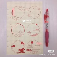 a notebook with some drawings on it next to a pen