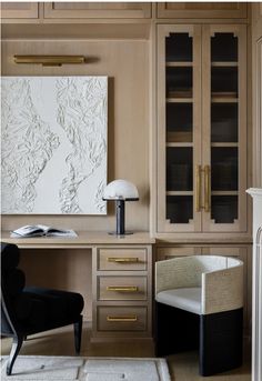 a desk with a chair and a painting on the wall behind it in a home office