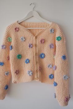 a cardigan sweater with flowers on it