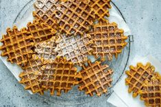 waffles on a glass plate with powdered sugar