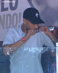 a man in white shirt and black hat at a concert