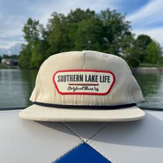 Expertly crafted: SLL PATCH BISCUIT ROPE HAT is a durable and comfortable cotton/poly blend with a plastic snapback for an adjustable fit. With UPF 50+ and water repellent properties, this hat protects from the sun and water while showcasing the OG SLL PATCH design.   * Cotton/Poly Blend *  Plastic Snapback * UPF 50+ * Water Repellent Sun And Water, Patch Design, Greek Life, Lake Life, Hat Designs, Trucker Cap, Upf 50, Repellent, Water Repellent