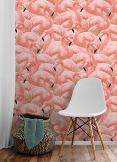 pink flamingo wallpaper in front of a white chair with a basket on the floor