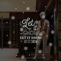 a window display with snowflakes on it and the words let it snow written in white