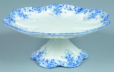 a blue and white cake plate sitting on top of a table