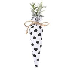 a black and white polka dot umbrella with a pineapple on the top, tied in twine