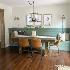 a dining room table with four chairs and a bench in front of it, along with pictures on the wall