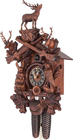 an ornate wooden cuckoo clock with deer and acorns