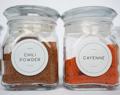 three jars filled with chili powder and cayenne sitting on top of a table