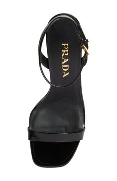 A sculptural heel with an iconic Prada triangular logo supports this minimalist ankle-strap sandal crafted of glossy calfskin leather. 3 1/2" (89mm) heel Adjustable ankle strap with buckle closure Leather upper, lining and sole Made in Italy Designer Shoes Sleek Leather Sandals With Glossy Finish, Sleek Glossy Leather Sandals, Luxury Heels With Glossy Finish And Open Heel, Luxury Glossy Open Heel Heels, Luxury Glossy Finish Heels With Open Heel, Glossy Ankle Strap Sandals For Evening, Glossy Finish Ankle Strap Sandals For Evening, Glossy Ankle Strap Heels For Evening, Sleek High Heel Sandals With Glossy Finish