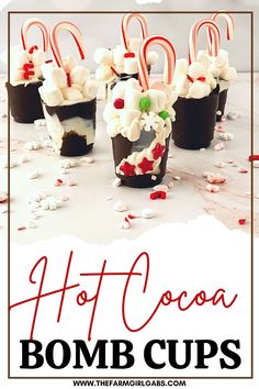 some candy canes and marshmallows are in cups with the words hot cocoa on them