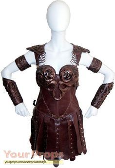 a female mannequin dressed in leather with armor on it's chest and arms