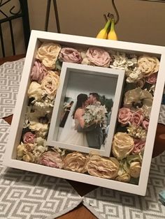 a wedding photo frame with flowers and bananas